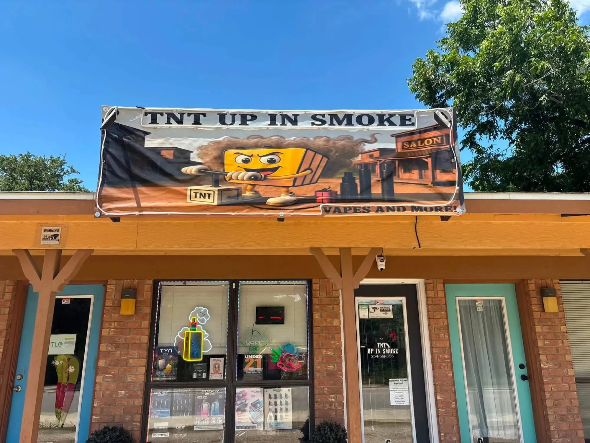 The front of TNT Up In Smoke on Hwy 317, with the shop's banner over the awning